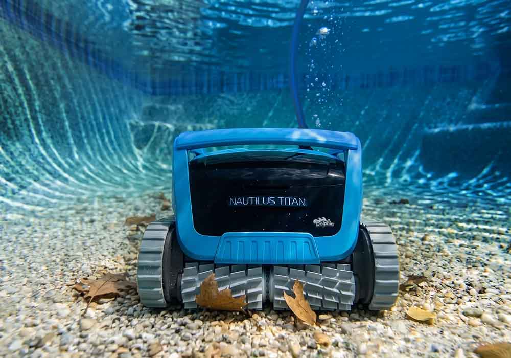 Dolphin Nautilus Titan with its twin scrubbing brushes on a pebble pool floor
